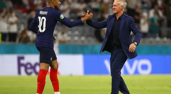 Mbappé i Deschamps, francuscy piłkarze, świętują sukces na boisku.