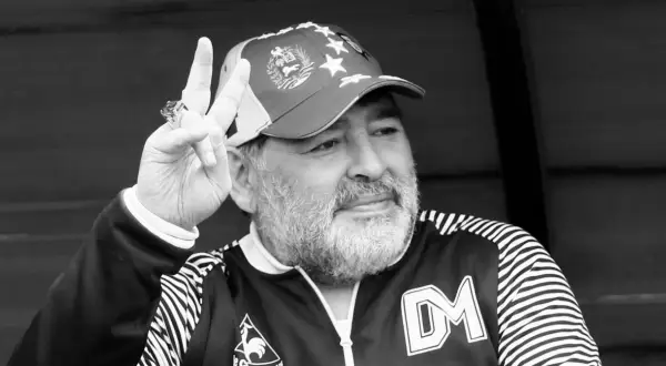 Diego Maradona, w czapce z gwiazdami, pokazuje znak pokoju. Ile lat ma Maradona? To pytanie zadają sobie fani.