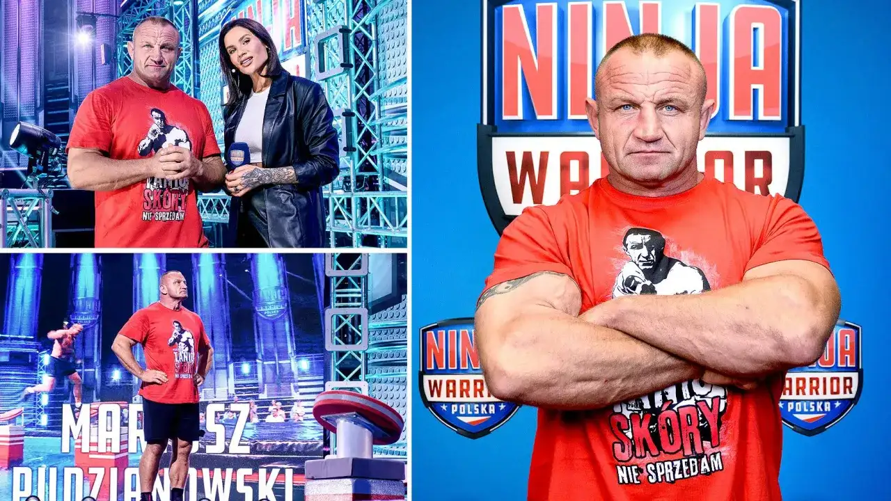 Mariusz Pudzianowski w czerwonej koszulce z napisem "Skóry nie sprzedam" na tle toru Ninja Warrior. Czy Mariusz Pudzianowski ma żonę? To pytanie nurtuje fanów.